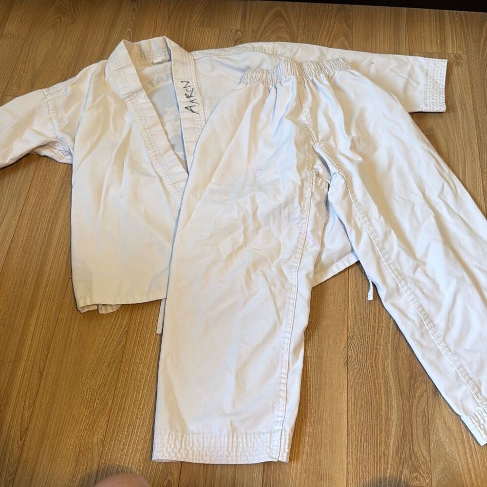 White martial arts uniform Size small   Has aaron written on it but being sold a
